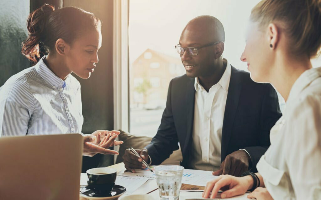 Professionals talking with each other over papers