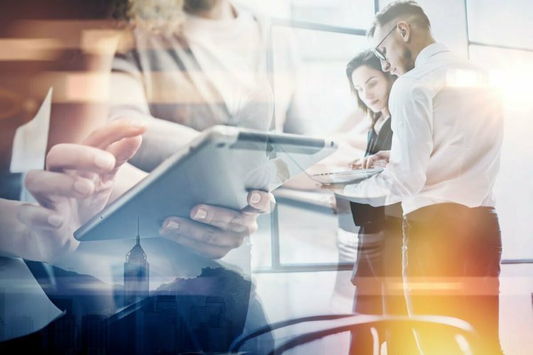 Professional people looking over tablet